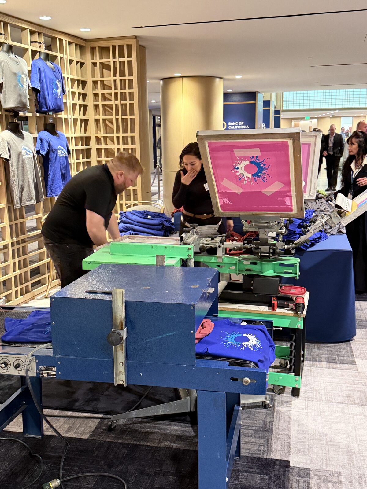 Conveyor dryer and screen press installed for onsite printing inside a hotel event foyer